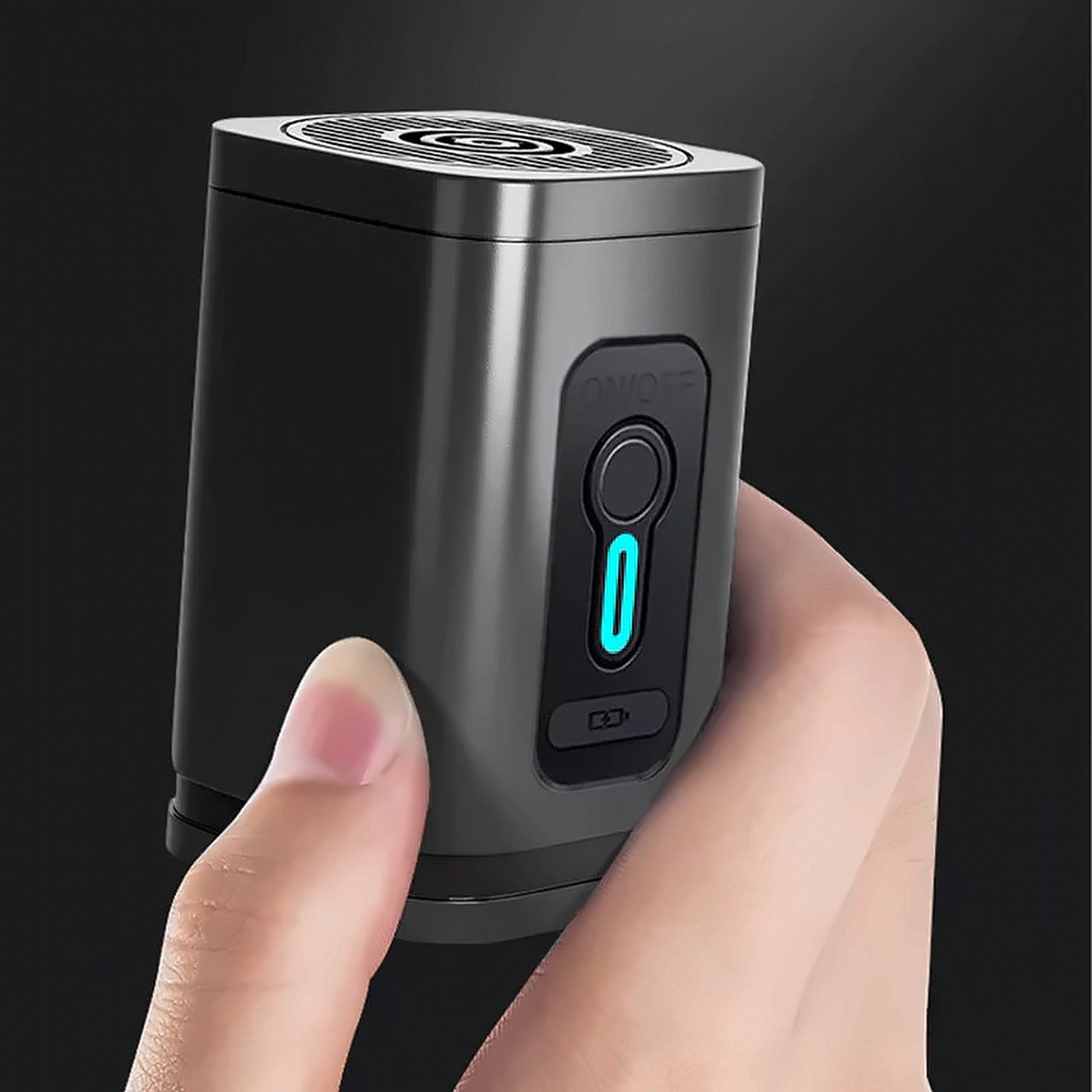 The rechargeable electric vacuum pump held in one hand, showing the power button and the charging port